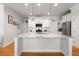 Well-lit kitchen with a large island, stainless steel appliances, white cabinets, and hardwood flooring at 1682 Mermentau St, Mount Pleasant, SC 29466