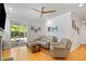 Bright living room with hardwood floors, a ceiling fan, and sliding glass doors leading to the outside at 1682 Mermentau St, Mount Pleasant, SC 29466