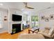 Cozy living room with hardwood floors, a fireplace, and sliding glass doors leading to the outside at 1682 Mermentau St, Mount Pleasant, SC 29466