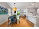 Open-concept living space with hardwood floors, neutral walls, modern lighting, and a cozy seating area at 1682 Mermentau St, Mount Pleasant, SC 29466