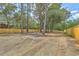 Large backyard featuring a wooden fence and mature trees offering shade and privacy at 1685 Old Military Rd, Charleston, SC 29412