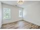 Bright bedroom with hardwood floors and two windows offering natural light at 1685 Old Military Rd, Charleston, SC 29412