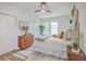 Well-lit bedroom features light wood floors, comfortable decor, and many windows at 1685 Old Military Rd, Charleston, SC 29412