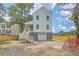 Rear exterior showcasing a charming two-story house with a spacious backyard and garage at 1685 Old Military Rd, Charleston, SC 29412