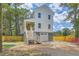 This home features a white exterior, a one car garage, and a covered porch with stairs at 1685 Old Military Rd, Charleston, SC 29412