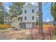 Rear exterior view of a charming home with a spacious yard and a garage at 1685 Old Military Rd, Charleston, SC 29412