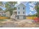 Rear exterior showcasing a charming two-story house with a spacious backyard and garage at 1685 Old Military Rd, Charleston, SC 29412