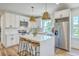Modern kitchen featuring white cabinets, stainless steel appliances, a large island, and pendant lighting at 1685 Old Military Rd, Charleston, SC 29412