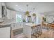 Bright kitchen with white cabinets, stainless steel appliances, a center island, and an adjacent dining area at 1685 Old Military Rd, Charleston, SC 29412