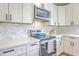 Modern kitchen featuring stainless steel appliances and white marble countertops at 1685 Old Military Rd, Charleston, SC 29412