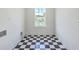 Laundry room features black and white checkered floors and window views at 1685 Old Military Rd, Charleston, SC 29412