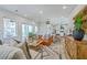 Bright, open-concept living room featuring hardwood floors, contemporary decor, and an abundance of natural light at 1685 Old Military Rd, Charleston, SC 29412