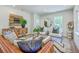 Cozy living room featuring a leather sofa, decorative pillows, and modern décor at 1685 Old Military Rd, Charleston, SC 29412