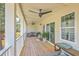 Inviting porch featuring comfortable seating, ceiling fans, and sliding glass doors at 1685 Old Military Rd, Charleston, SC 29412