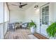 Inviting front porch with comfortable seating and a ceiling fan, creating a perfect outdoor space at 1685 Old Military Rd, Charleston, SC 29412