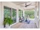 Covered porch area featuring a bench seat, decorative pillows, and a fern, enhancing the outdoor ambiance at 1685 Old Military Rd, Charleston, SC 29412
