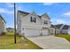 Beautiful two-story home with a three-car garage and a well-manicured lawn at 178 Grange Cir, Summerville, SC 29486