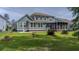 Expansive backyard featuring a well-manicured lawn, screened porch, and beautiful landscaping at 183 Calm Water Way, Summerville, SC 29486