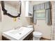 Bathroom with a dark brown vanity and an oval mirror above it at 1879 Richmond St, Charleston, SC 29407