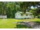 Adorable single-level home with a detached shed, green trim, and a spacious yard perfect for outdoor activities at 1879 Richmond St, Charleston, SC 29407