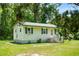 Inviting single-story home with green shutters, a well-maintained lawn, and easy access stairs to the front door at 1879 Richmond St, Charleston, SC 29407