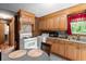 Kitchen with oak cabinets, appliances, and a dining area at 1879 Richmond St, Charleston, SC 29407