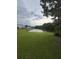 A lush lawn leads to a serene pond, nature's view just outside your door at 207 Congaree River Dr, Summerville, SC 29485