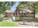 Large backyard with patio furniture, mature trees, and a cozy fire pit area at 208 Janice St, Goose Creek, SC 29445