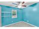A well-lit bedroom with neutral carpet and bright blue walls at 208 Janice St, Goose Creek, SC 29445