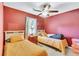 Cozy bedroom featuring twin beds, a ceiling fan, and warm, inviting decor at 208 Janice St, Goose Creek, SC 29445