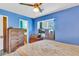 View of the bedroom, showing natural light, wood furniture, and access to an ensuite bathroom at 208 Janice St, Goose Creek, SC 29445