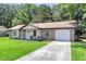 Charming single-story home with brick accents, a well-manicured lawn, and attached garage at 208 Janice St, Goose Creek, SC 29445