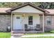 Inviting front porch with chairs and a table, perfect for relaxing outdoors at 208 Janice St, Goose Creek, SC 29445