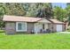 Inviting brick home with a manicured lawn, shaded porch, and attached garage at 208 Janice St, Goose Creek, SC 29445