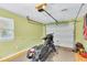 Spacious garage featuring a motorcycle, overhead door, and bright lighting at 208 Janice St, Goose Creek, SC 29445