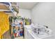 Functional laundry room with washer, dryer, shelving, and essential supplies at 208 Janice St, Goose Creek, SC 29445