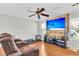 Cozy living room featuring wood floors, a modern TV, and comfortable seating for relaxation at 208 Janice St, Goose Creek, SC 29445