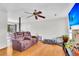 Comfortable living room featuring a plush reclining sofa, wood floors, and a ceiling fan at 208 Janice St, Goose Creek, SC 29445