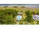 Aerial view featuring a community pool, well-maintained greenery, and waterfront access in a desirable neighborhood at 2312 Rushland Landing Rd, Johns Island, SC 29455