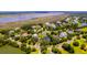 Aerial view of a residential area showcasing beautiful homes, lush greenery, and serene water features at 2312 Rushland Landing Rd, Johns Island, SC 29455