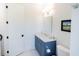 This bathroom features a navy blue vanity with white countertop, toilet, and dark hardware at 2312 Rushland Landing Rd, Johns Island, SC 29455