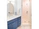 Bathroom features a blue vanity with a white countertop and a light tiled shower with glass door at 2312 Rushland Landing Rd, Johns Island, SC 29455