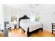 Stylish bedroom with dark wood frame and neutral bedding and hardwood floors at 2312 Rushland Landing Rd, Johns Island, SC 29455