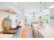 Bright, open kitchen with white cabinets, stainless steel appliances, hardwood floors, and an adjacent dining area at 2312 Rushland Landing Rd, Johns Island, SC 29455