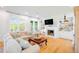 Inviting living room features a comfortable sofa, fireplace, built-in bookshelves, and large windows at 2312 Rushland Landing Rd, Johns Island, SC 29455