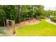 Lovely playground area surrounded by mature trees and lush greenery, complete with swings and a slide at 2312 Rushland Landing Rd, Johns Island, SC 29455