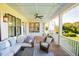 Charming porch featuring wicker furniture with a view of the manicured backyard at 2312 Rushland Landing Rd, Johns Island, SC 29455