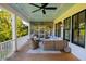 Relaxing screened porch with comfortable seating and a ceiling fan at 2312 Rushland Landing Rd, Johns Island, SC 29455