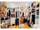 Spacious walk-in closet with custom shelving and rods for organized storage at 2312 Rushland Landing Rd, Johns Island, SC 29455