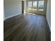 Bright bedroom with wood floors and multiple windows allowing plenty of natural light at 235 Denham St, Summerville, SC 29486
